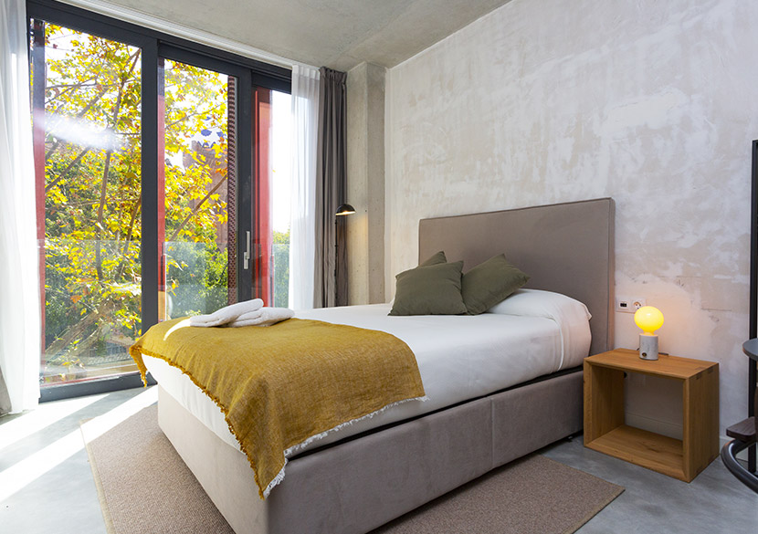belvillage-diputacio-bedroom-floor-to-ceiling-window-nature-view.jpg