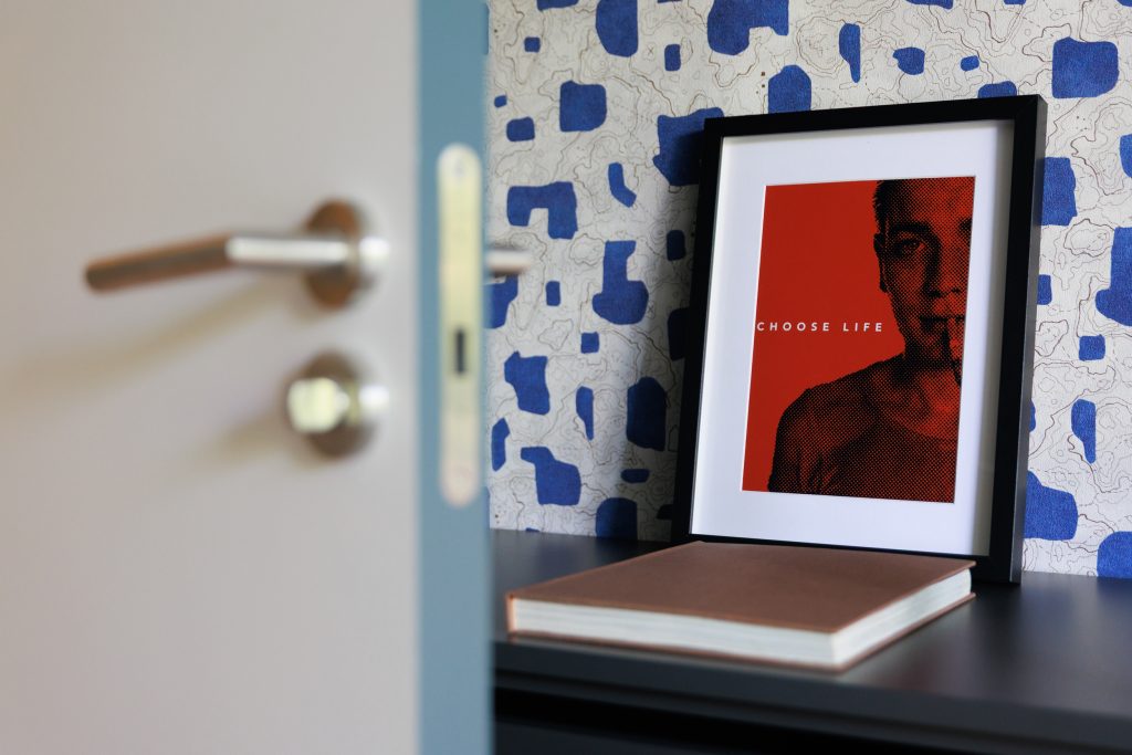 Framed artwork on a bedside shelf in a Gavà apartment.