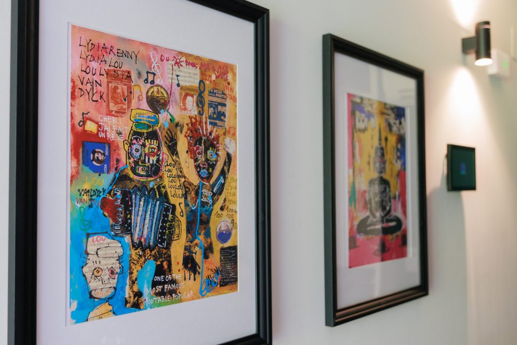 Colourful framed artworks in the entrance of a Gavà apartment.